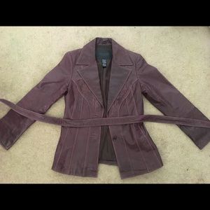 Genuine leather lined purple jacket with floral appliqué detail and belt.
